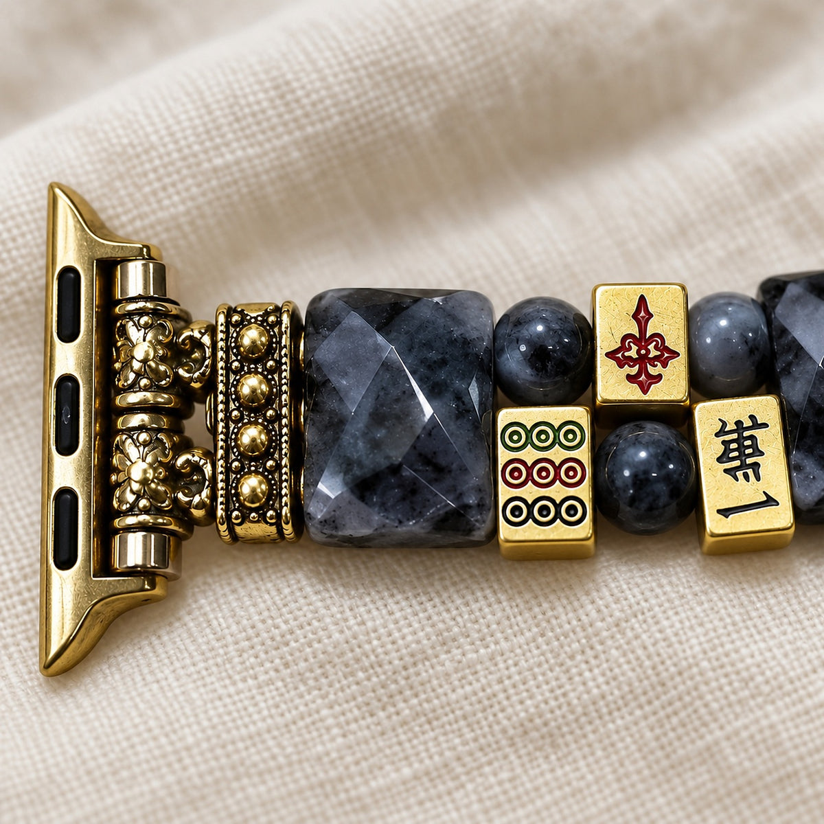 Close-up of the gold mahjong tile charms, labradorite and antique-gold connector