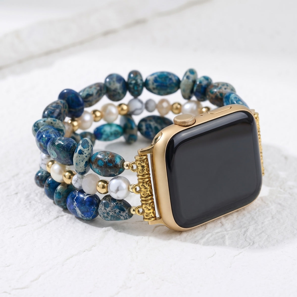 Still Waters blue sea sediment jasper and pearl stretch Apple Watch strap with gold watch